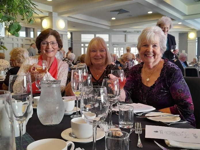 A group of women sitting at a table

Description automatically generated